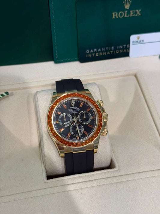 Rolex Yellow Gold Daytona Watch - 40 MM - Oysterflex Strap - Black Diamond Dial - Orange Baguette Sapphire Bezel - 116588SACO