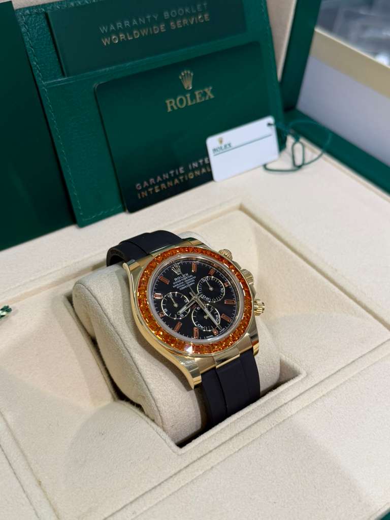 Rolex Yellow Gold Daytona Watch - 40 MM - Oysterflex Strap - Black Diamond Dial - Orange Baguette Sapphire Bezel - 116588SACO