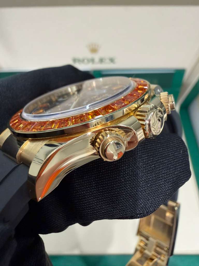 Rolex Yellow Gold Daytona Watch - 40 MM - Oysterflex Strap - Black Diamond Dial - Orange Baguette Sapphire Bezel - 116588SACO