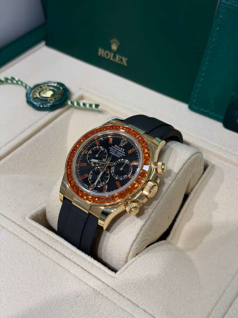 Rolex Yellow Gold Daytona Watch - 40 MM - Oysterflex Strap - Black Diamond Dial - Orange Baguette Sapphire Bezel - 116588SACO