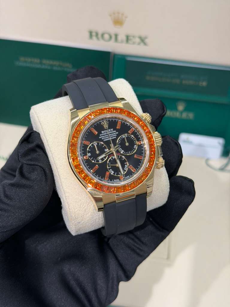 Rolex Yellow Gold Daytona Watch - 40 MM - Oysterflex Strap - Black Diamond Dial - Orange Baguette Sapphire Bezel - 116588SACO
