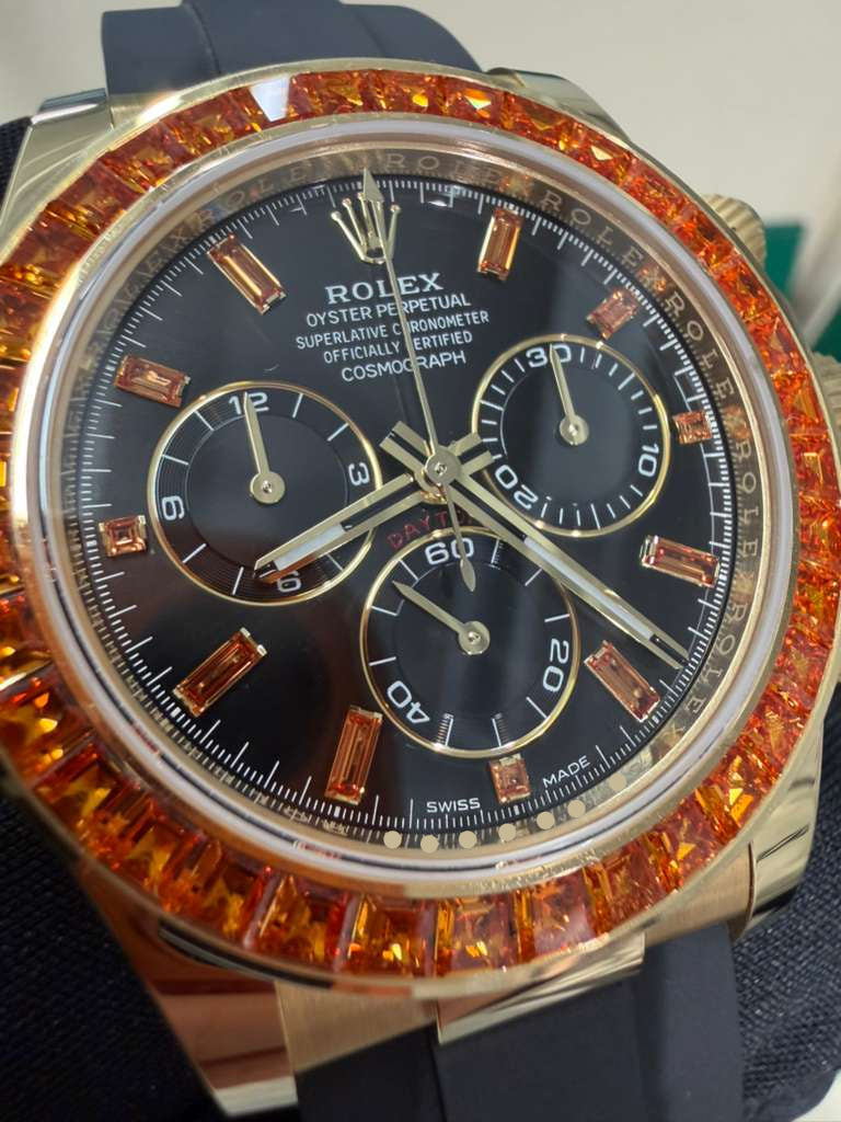 Rolex Yellow Gold Daytona Watch - 40 MM - Oysterflex Strap - Black Diamond Dial - Orange Baguette Sapphire Bezel - 116588SACO