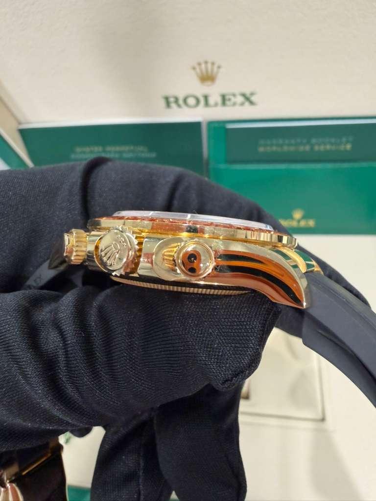 Rolex Yellow Gold Daytona Watch - 40 MM - Oysterflex Strap - Black Diamond Dial - Orange Baguette Sapphire Bezel - 116588SACO