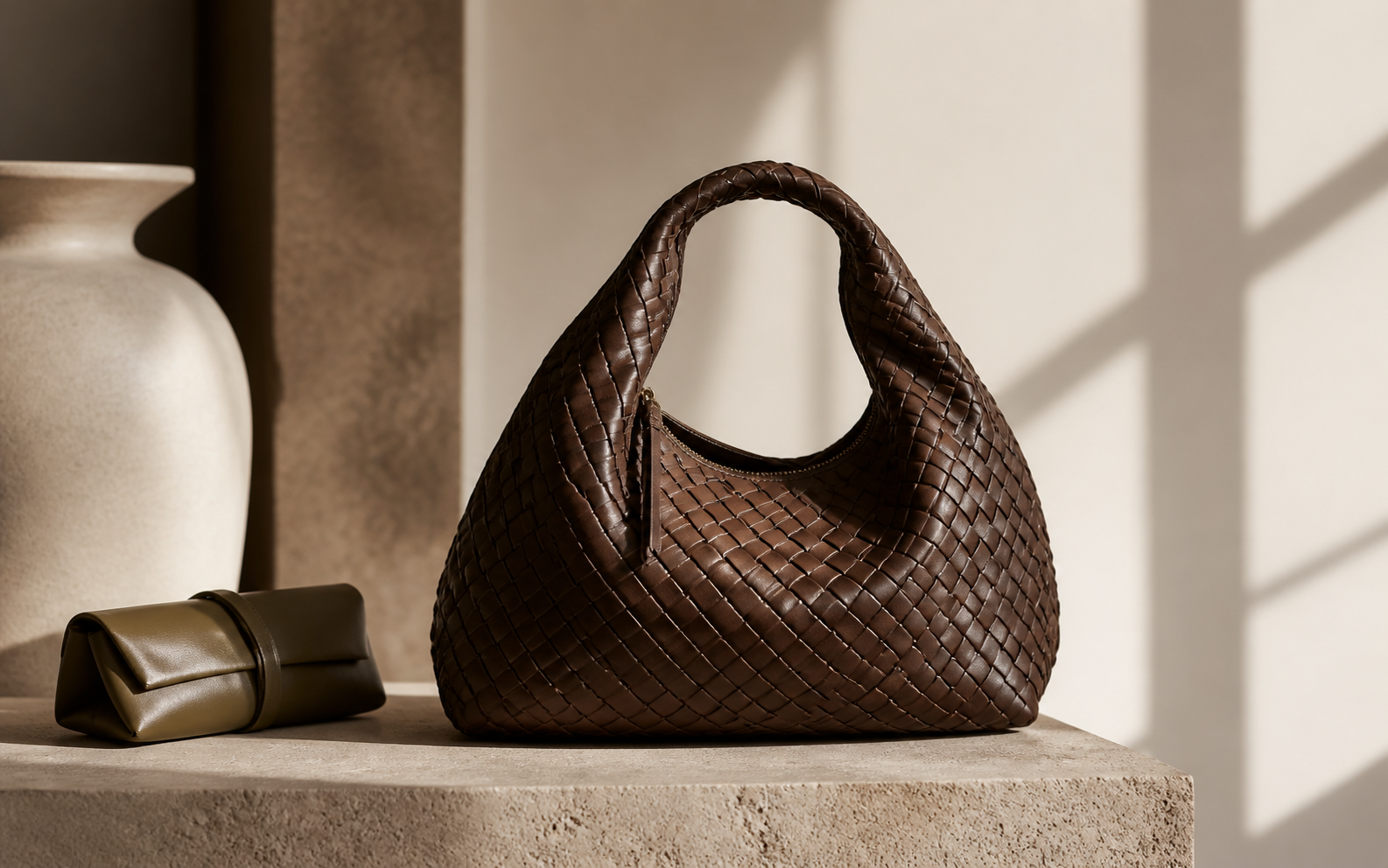 Woven leather handbag in a warm editorial studio