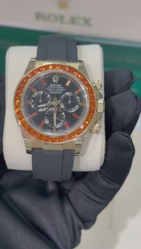 Rolex Yellow Gold Daytona Watch - 40 MM - Oysterflex Strap - Black Diamond Dial - Orange Baguette Sapphire Bezel - 116588SACO
