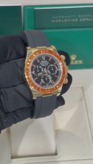 Rolex Yellow Gold Daytona Watch - 40 MM - Oysterflex Strap - Black Diamond Dial - Orange Baguette Sapphire Bezel - 116588SACO